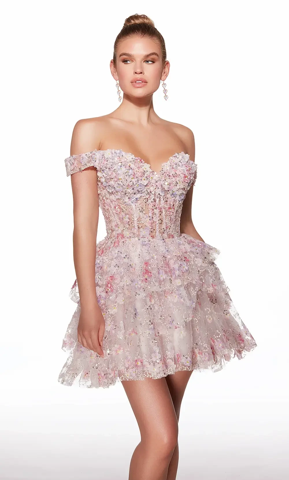 A model wearing a short, off-the-shoulder pink dress with floral embellishments and a ruffled skirt.